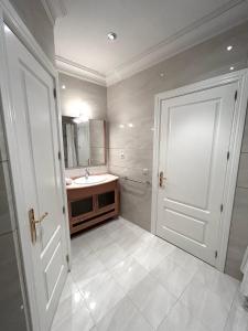 a bathroom with a sink and a mirror at PdV rooms in Madrid