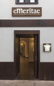 an entrance to a building with a sign on it at Hostal Emeritae in Mérida