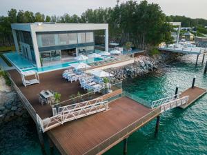 an aerial view of a house on a dock in the water at Nurai Water Villa By Luxury Explorers Collection in Abu Dhabi