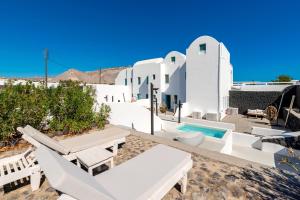 a villa with a swimming pool and white architecture at Santa Irina Luxury Sunny Lofts in Perivolos