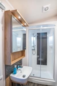a bathroom with a sink and a shower at Luxury 8 Berth-Wheelchair Access in Port Seton
