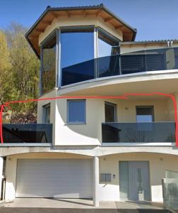 two views of a house with a garage at WernerS home in Markt Sankt Florian