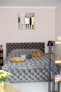 a bed with two pillows on it in a room at Dzintara apartamenti in Kuldīga