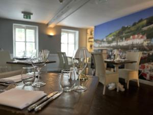 a table with wine glasses sitting on top of it at Chateau La Chaire Hotel in Rozel
