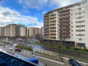 a city with tall buildings and a street with cars at Cozy Luxury Apartments - Coresi Mall #Brasov in Braşov