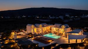 an aerial view of a house with a swimming pool at Santa Irina Luxury Sunny Lofts in Perivolos