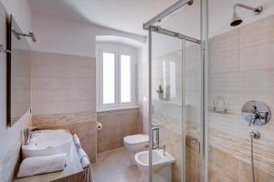 e bagno con servizi igienici, lavandino e doccia. di Le Bicocche di Joyce - elegant and quiet in the center a Trieste