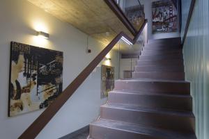a staircase in a house with a wooden ceiling at Hostal Emeritae in Mérida