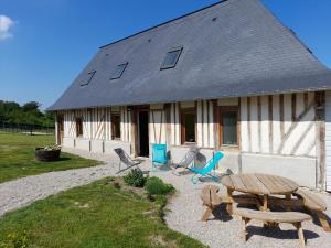 une maison avec des chaises et une table devant elle dans l'établissement Gîte de la giroterie, maison à la campagne au calme, vue sur la vallée, 