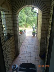 an archway leading into a brick hallway with plants at Haus-Panoramablick in Sundern