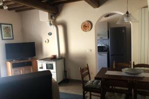 a kitchen and dining room with a table and a television at Il casale del Trebbio in Pila
