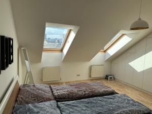 a bedroom with a large bed in a attic at Dachgeschoss City Apartment in Zentrum Wiens in Vienna