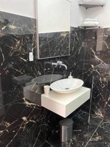 a bathroom with a sink and a mirror at Residenza da Zia Donata in Ercolano