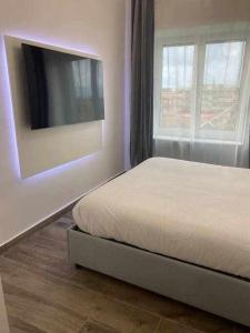 1 dormitorio con 1 cama y TV de pantalla plana en Residenza da Mimi, en Ercolano