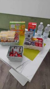 a white table with three containers of food on it at Residenza da Mimi in Ercolano