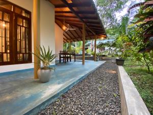 a porch of a house with plants on it at See Turtle Villa in Tangalle