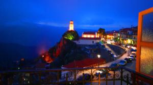a lighthouse sitting on top of a mountain at night at Hotel Parnassos in Arachova