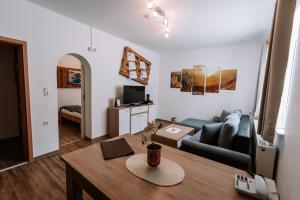 a living room with a couch and a table at Gasthof Familie Gruber Hotel-Pension in Spital am Pyhrn