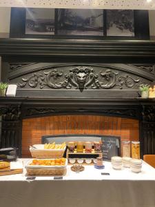 a table with pastries and other food items on it at Hôtel du Château in Villers-lès-Nancy