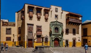 a large building with people walking in front of it at Casa Colonial Vegueta in Las Palmas de Gran Canaria