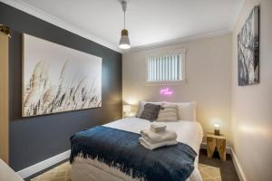 a bedroom with a bed with a blue blanket at Haven on Timsbury, Urban Escape near Mona in Derwent Park