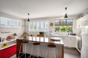 a kitchen with white cabinets and a red rug at Haven on Timsbury, Urban Escape near Mona in Derwent Park