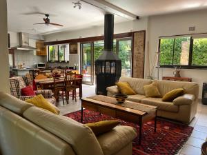 a living room with two couches and a stove at Santika Villa Stellenbosch in Stellenbosch