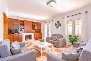 a living room with couches and a fireplace at Villa Marques by Villa Plus in Cala'n Porter