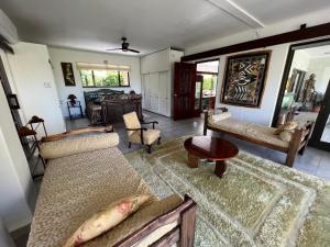 a living room with a couch and a table at Santika Villa Stellenbosch in Stellenbosch