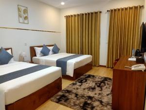 Ліжко або ліжка в номері Nimith Hotel & Restaurant