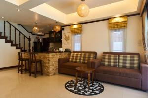 a living room with two couches and a bar at Ananda Private Pool Villa, Ao Nang in Krabi town