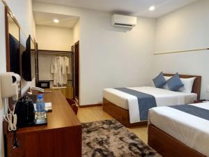 Ліжко або ліжка в номері Nimith Hotel & Restaurant