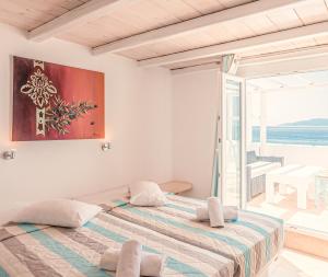 a bedroom with a bed with a view of the ocean at Paradise Beach Resort in Paradise Beach