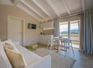 a living room with a white couch and a table at Agriturismo Terre degli Angeli in Pietra Ligure
