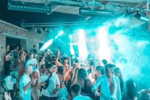a crowd of people in a room with lights at Paradise Beach Resort in Paradise Beach