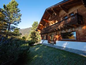 a house with a balcony on the side of it at Chalet Chalet Le Haut Pré by Interhome in Villars-sur-Ollon