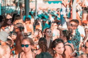 a crowd of people walking down a crowded street at Paradise Beach Resort in Paradise Beach
