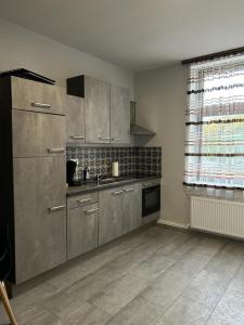 a kitchen with stainless steel appliances and a window at Sia Apartments Hotel in Essen