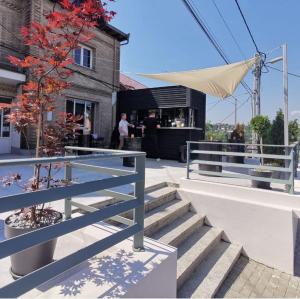 a set of stairs with a fence and a tree at Apartament B&B Cajvana in Cajvana