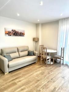 a living room with a couch and a table at Apartamento La Muralla 2C in Aguilar de Campóo