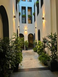 a courtyard with potted plants in a building at Posada de los Venerables in Seville