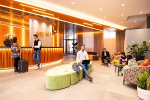 a group of people sitting in a lobby at lyf Schönbrunn Vienna in Vienna