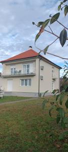a large white house with a red roof at My Home in Arandjelovac