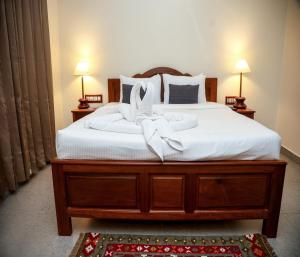 a bedroom with a bed with a bow on it at Mango Hill La Serene Puducherry in Pūrnānkuppam