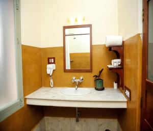a bathroom with a sink and a mirror at Mango Hill La Serene Puducherry in Pūrnānkuppam