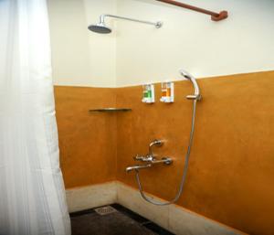 a shower in a bathroom with a shower curtain at Mango Hill La Serene Puducherry in Pūrnānkuppam