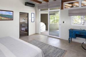 a bedroom with a bed and a blue dresser and a window at Entire Tocayo Steps to Beach and Surf 4BD Condo with Master Suite in Sayulita