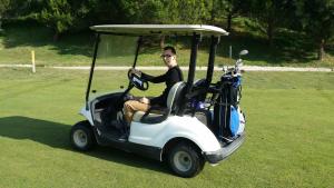 a man driving a golf cart in a field at Detached Villa 4 bed Duquesa with Private infinity pool close to port and beach in Manilva