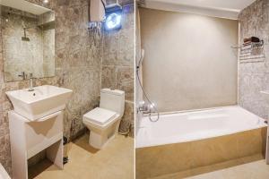 a bathroom with a sink and a toilet and a shower at FabHotel Dreams Inn in Pune