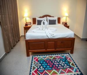 a bedroom with a bed with a bow on it at Mango Hill La Serene Puducherry in Pūrnānkuppam
